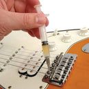 Aplicación del lubricante anti-fricción PW-LBK-01 en puente de guitarra